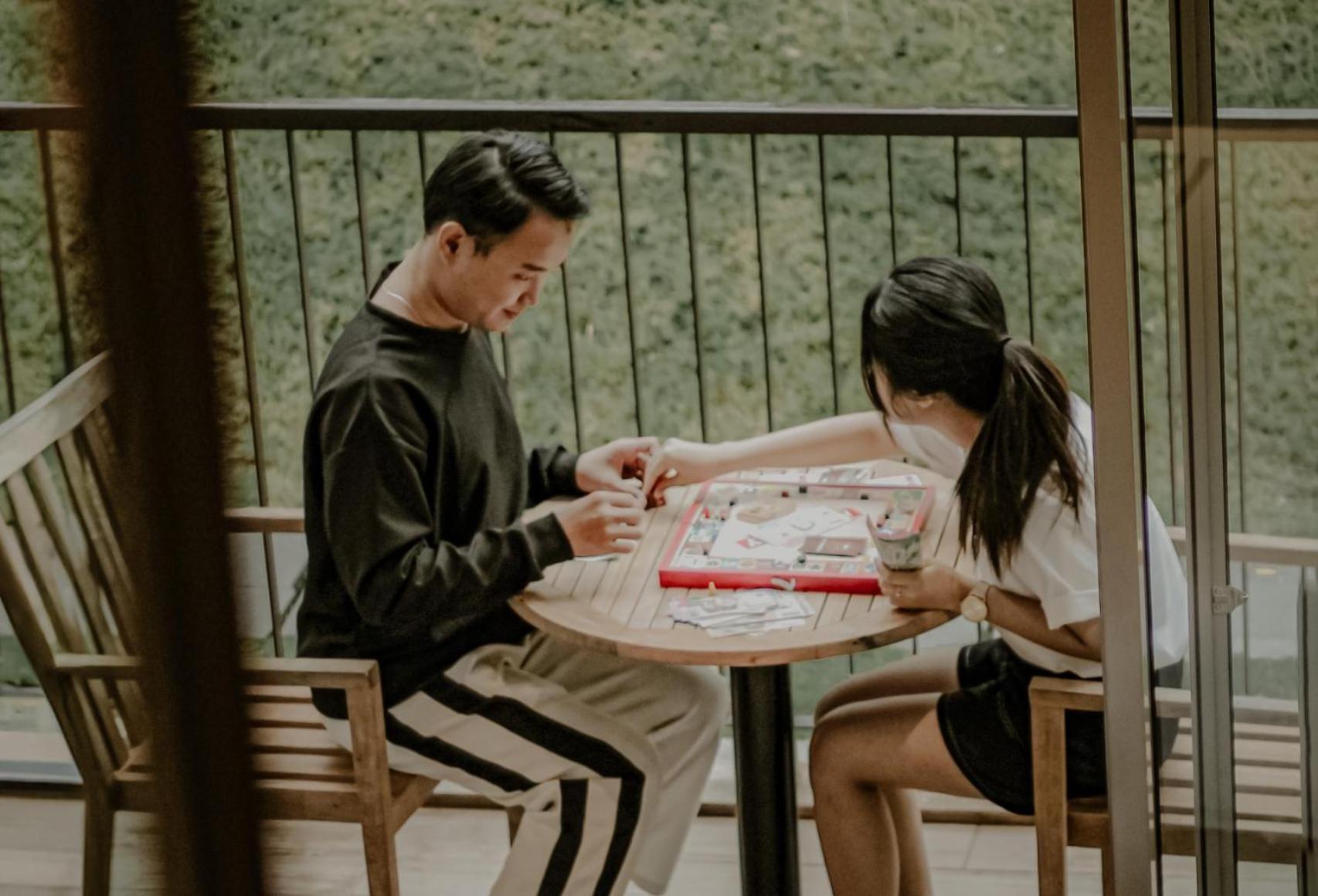 The Botanica Sanctuary Hotel Puncak Exterior photo Two people playing a game of Chinese chess